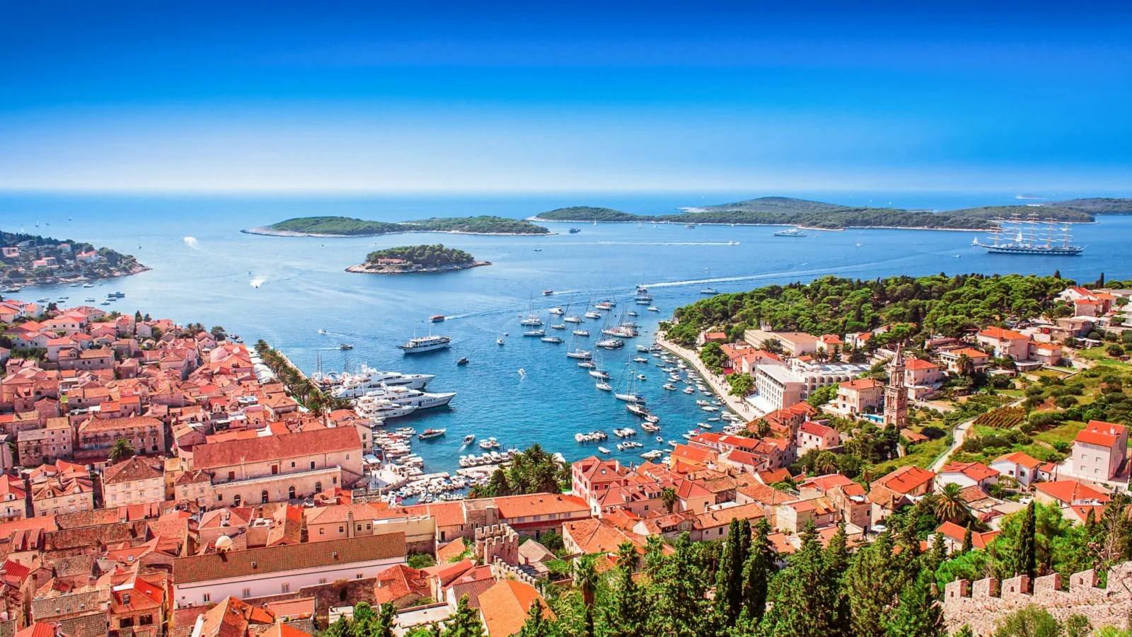 Hvar town and harbour with anchored yachts, the Pakleni Islands in the background